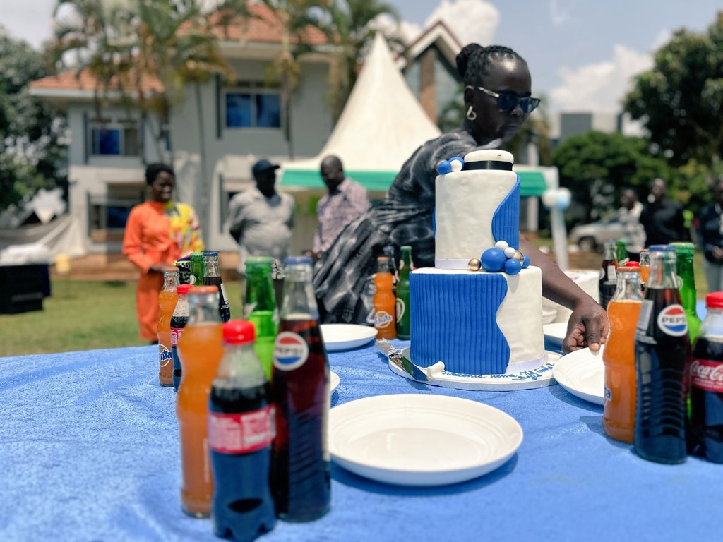 Pupils standing by a large cake